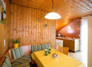 a dining room with a table and a kitchen at Ferienhaus Endl in Freyung