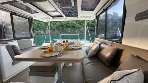 a table and a couch in a boat at Unusual night in catamaran with dinner in Grand Case