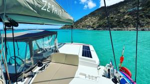 a boat in the water with a view of the ocean at Unusual night in catamaran with dinner in Grand Case