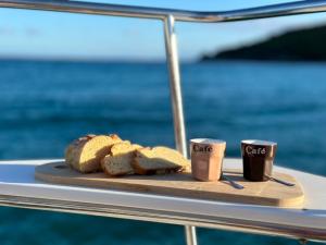 a plate of bread and two coffee cups on a boat at Room in Boat - Unusual night in catamaran with dinner in Grand Case