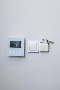 a white microwave on a wall with a key at Luxury Downtown Apartment Α2 in Thessaloniki