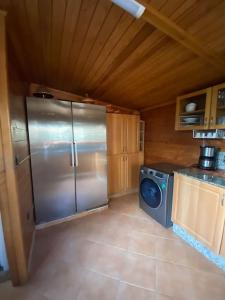 a kitchen with a stainless steel refrigerator and a stove at Appart bien équipé avec jardin privé à California in Casablanca