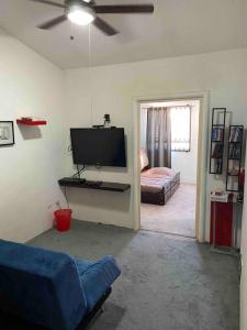 een woonkamer met een tv en een bank en een bed bij Casa para toda la familia in Ensenada