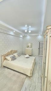 a bedroom with a large bed in a room at # 268 Светлая и уютная квартира in Atyraū