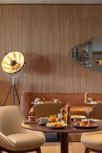 a dining room with a table with food on it at EVOLUTION Cascais-Estoril Hotel in Estoril