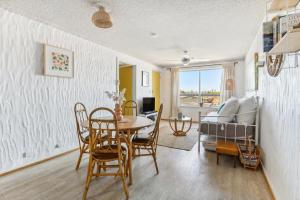 a living room with a table and chairs and a bed at Gorgeous Gordon Street Getaway in Glenelg