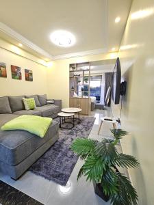 a living room with a couch and a tv at Cosynook Home Valley Heights in Nairobi