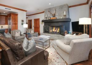 a living room with couches and a fireplace at Hummingbird C102 Condo in Beaver Creek