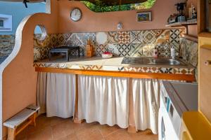a kitchen with a counter and a sink in a house at Apartment Opatija with Garden and Seaview in Opric
