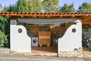 a house with a patio with a washer and dryer at Apartment Opatija with Garden and Seaview in Opric