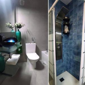 a bathroom with a toilet and a sink and a shower at Areia StayInn Beach Apartment in Árvore