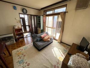 a living room with a chair and a window at 静かな田舎の一軒家～空き家を活用したDIY住宅～ 