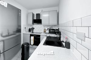 a kitchen with a sink and a counter top at Luxurious 1 Bedroom Apartment Sleeps 3-4 in Manchester
