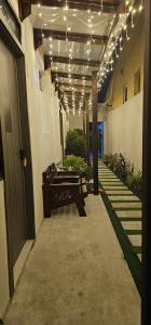 a hallway with a bench and lights on a building at Blue Haven Retreat in Thulusdhoo