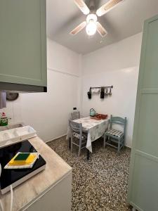 a kitchen with a table and a table and chairs at Cozy Flat Loutra Aidipsou in Loutra Edipsou