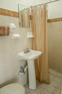 a bathroom with a sink and a toilet and a shower at Casa Mazunte Tierra Viva in Mazunte