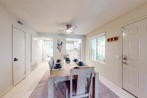 a dining room with a long table and chairs at Palms & Peaks, Unit F37 Permit #43588 in Palm Springs