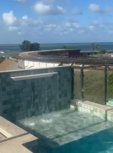a view of a building with a swimming pool at Tambaú Israel Flat 417 in João Pessoa