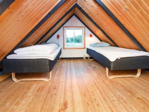 two beds in a room with a roof at Holiday Home Kræ in Klegod