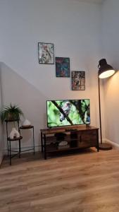 a living room with a flat screen tv on a table at Cosy 2 Bedroom Apartment in Birmingham