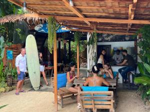 a group of people sitting at a restaurant with a surfboard at Wave Heaven 9 meters to cloud 9 in General Luna
