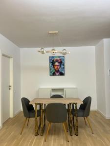 a dining room with a table and chairs at C-entral Apartments Bucharest with Private Parking in Bucharest
