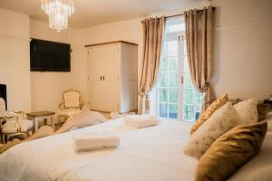 a bedroom with a large bed with a large window at The Grove Ferry Inn in Chislet