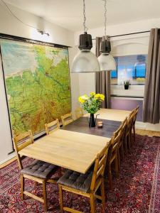 a dining room table with chairs and a large map on the wall at Großzügiges Loft in zentraler Lage in Braunschweig