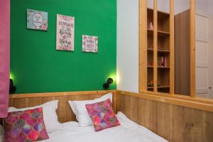 a bedroom with a bed with a green wall at Mill Central 2 in Sibiu