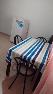 a table with a striped blanket on a chair at Bella Vista in Gobernador Gregores