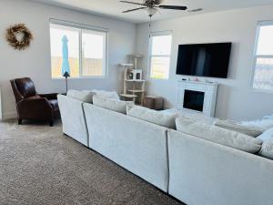 a living room with a white couch and a tv at Modern Ripon Home - Whole House with Garage in Ripon