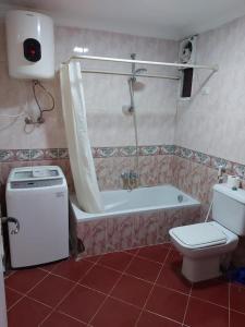 łazienka z wanną, toaletą i prysznicem w obiekcie Ground floor villa with private garden, parking and shared swimming pool w mieście El `Agûza