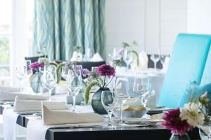 a table with wine glasses and flowers on it at Dorint Strandresort & Spa Westerland/Sylt in Westerland