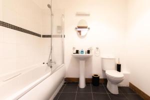 a bathroom with a toilet and a sink and a shower at Noir - 2 Bedroom Flat - Sleeps 5 with Parking in Southampton
