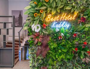 a sign that reads best hotel lobby with plants and flowers at BEST HOTEL KADIKOY in Istanbul