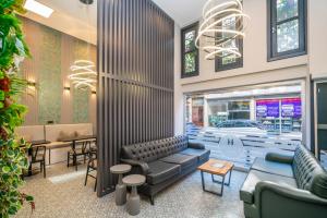 a waiting room with couches and tables and a chandelier at BEST HOTEL KADIKOY in Istanbul