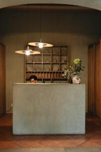 a man standing behind a counter in a kitchen at Los Pilares Hotel in Oaxaca City