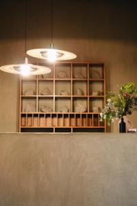 a kitchen with two lights and a shelf with plates at Los Pilares Hotel in Oaxaca City