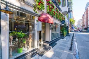 a street view of a store with a red an avertisement at BEST HOTEL KADIKOY in Istanbul