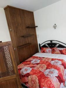 a bedroom with a bed with a red and white comforter at Appartement au centre de Rabat à Hassan. in Rabat