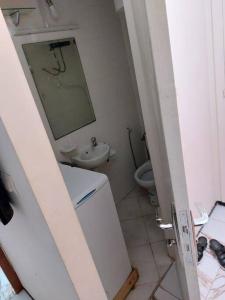 a bathroom with a sink and a toilet and a mirror at Appartement au centre de Rabat à Hassan. in Rabat