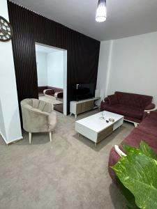 a living room with a couch and a table at Furnished Two bedroom apartment in Irbid in petra st in Irbid