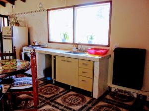 a kitchen with a sink and a refrigerator at Casa Samachiy in Humahuaca