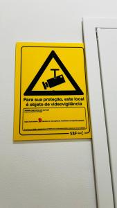 a sign on a door with a hazard sign on it at Apartamento Sebastian in Lisbon