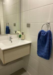 a bathroom with a sink and a blue towel at Departamento Excelente Ubicación in Concepción