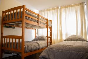 1 dormitorio con 2 literas y ventana en Departamento royal marine, en Iquique