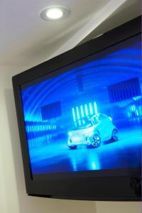 a television screen with a car on it at Just a B in Winchester