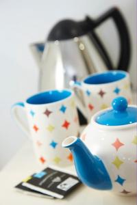 two cups and a tea pot on a table at Just a B in Winchester