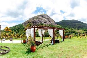 a wedding gazebo with a mountain in the background at Flat na natureza in Bonito