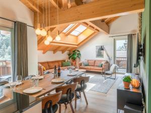 a dining room and living room with a table and chairs at Drei Berge Top 7 in Saalbach Hinterglemm